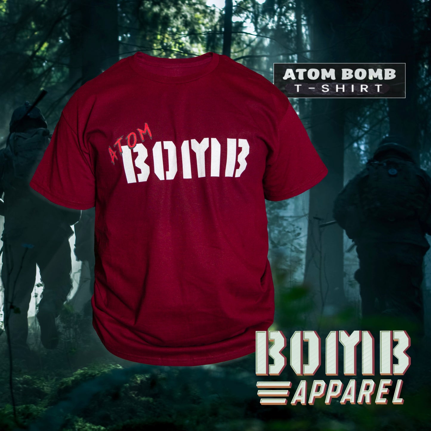 A maroon-colored, short-sleeve men's t-shirt with 'ATOM BOMB' printed across the chest, displayed in a forest setting with a camouflage pattern in the background.