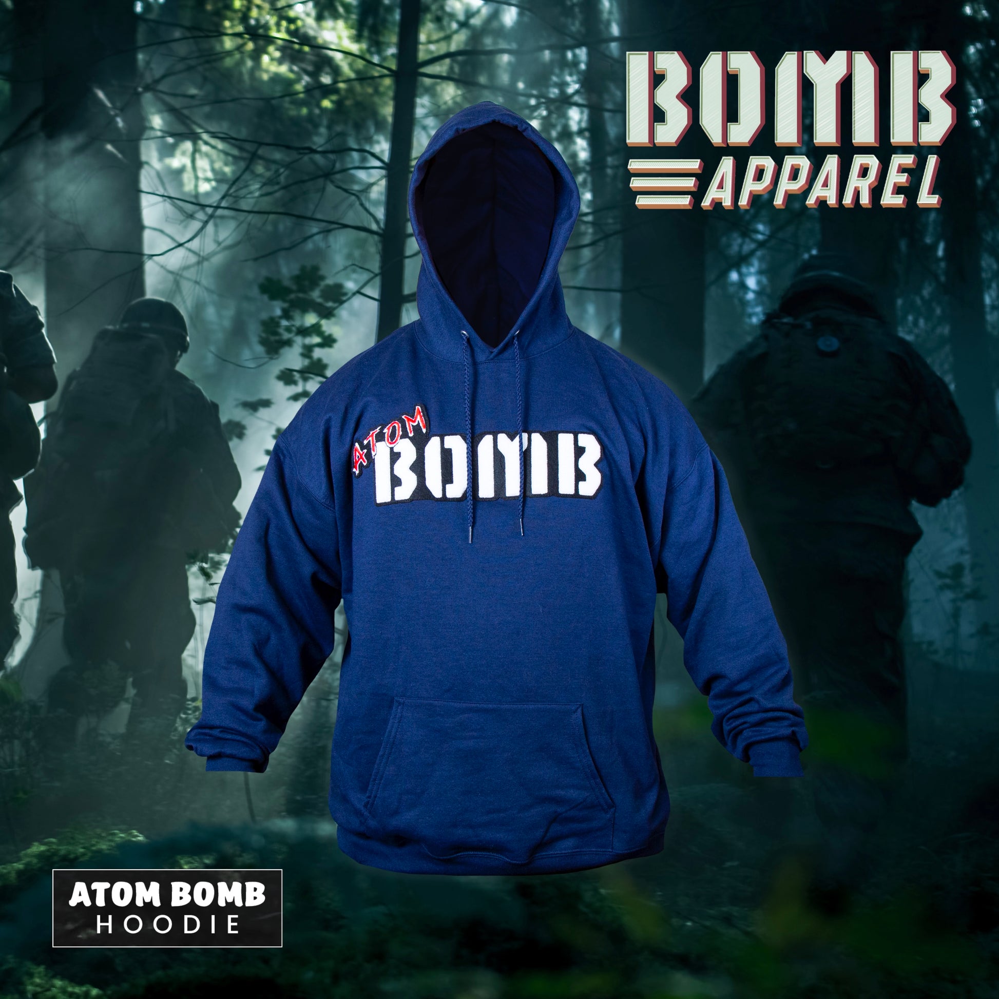 A navy fleece hoodie with the Atom Bomb brand logo stitched across the chest, featuring a hood, ribbed cuffs, and a front kangaroo pocket, displayed in a forest setting with a military-themed backdrop.